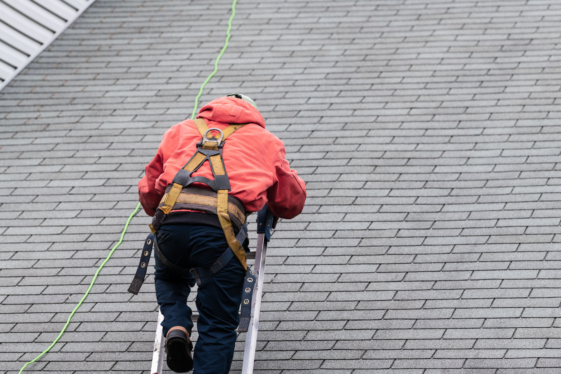man conducting a roof inspection